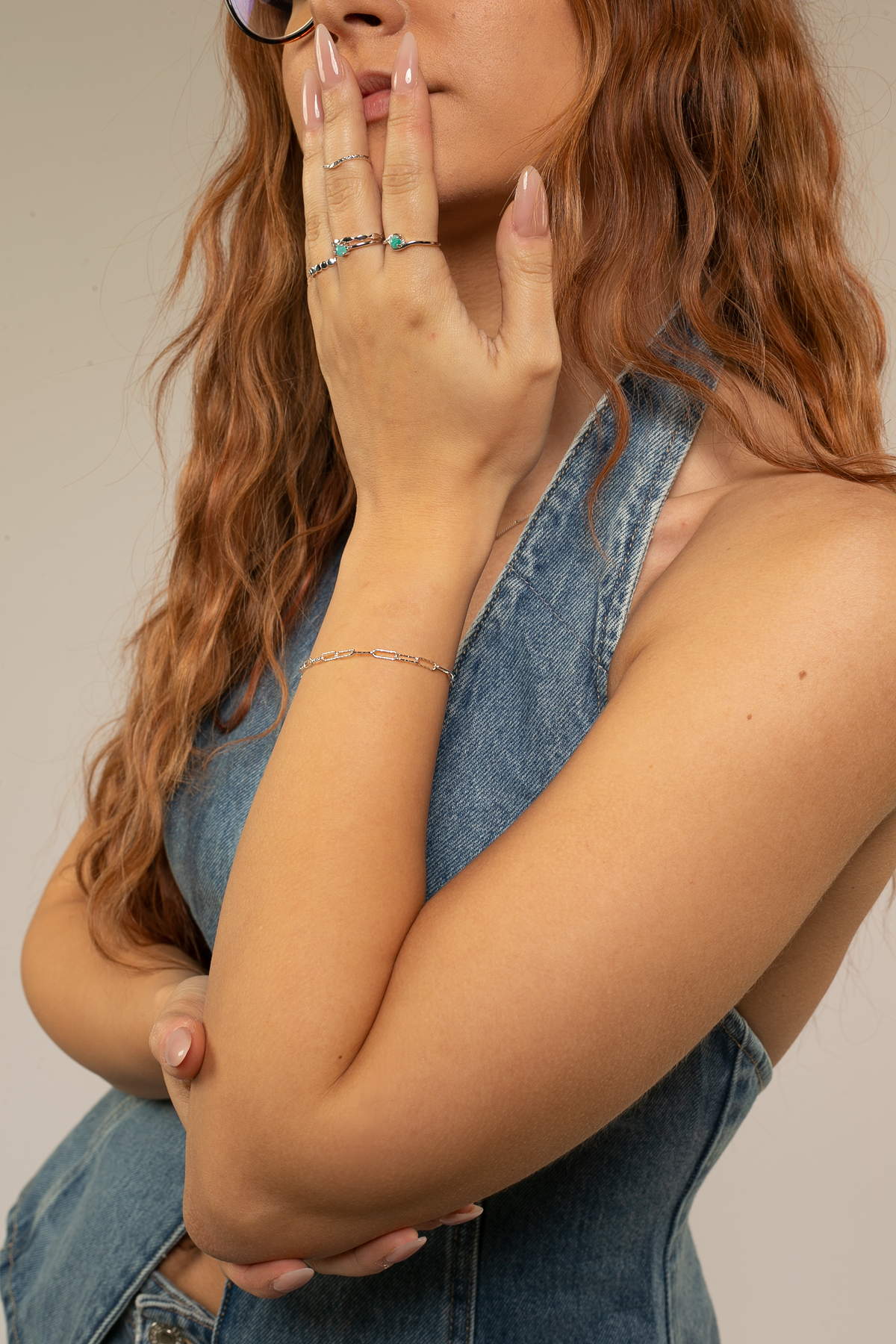 Girl wearing ring stack and paperclip bracelet in silver and amazonite