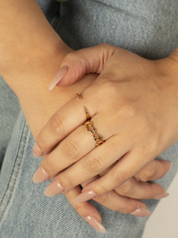 Intricato and open molten rings on hand in gold vermeil