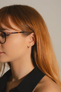 Woman wearing lab grown diamond ear stack in gold vermeil