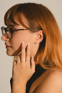 Woman wearing sparkling lab diamond rings in gold vermeil