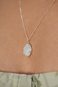 Flora Mother Of Pearl leaf pendant in silver on satellite chin
