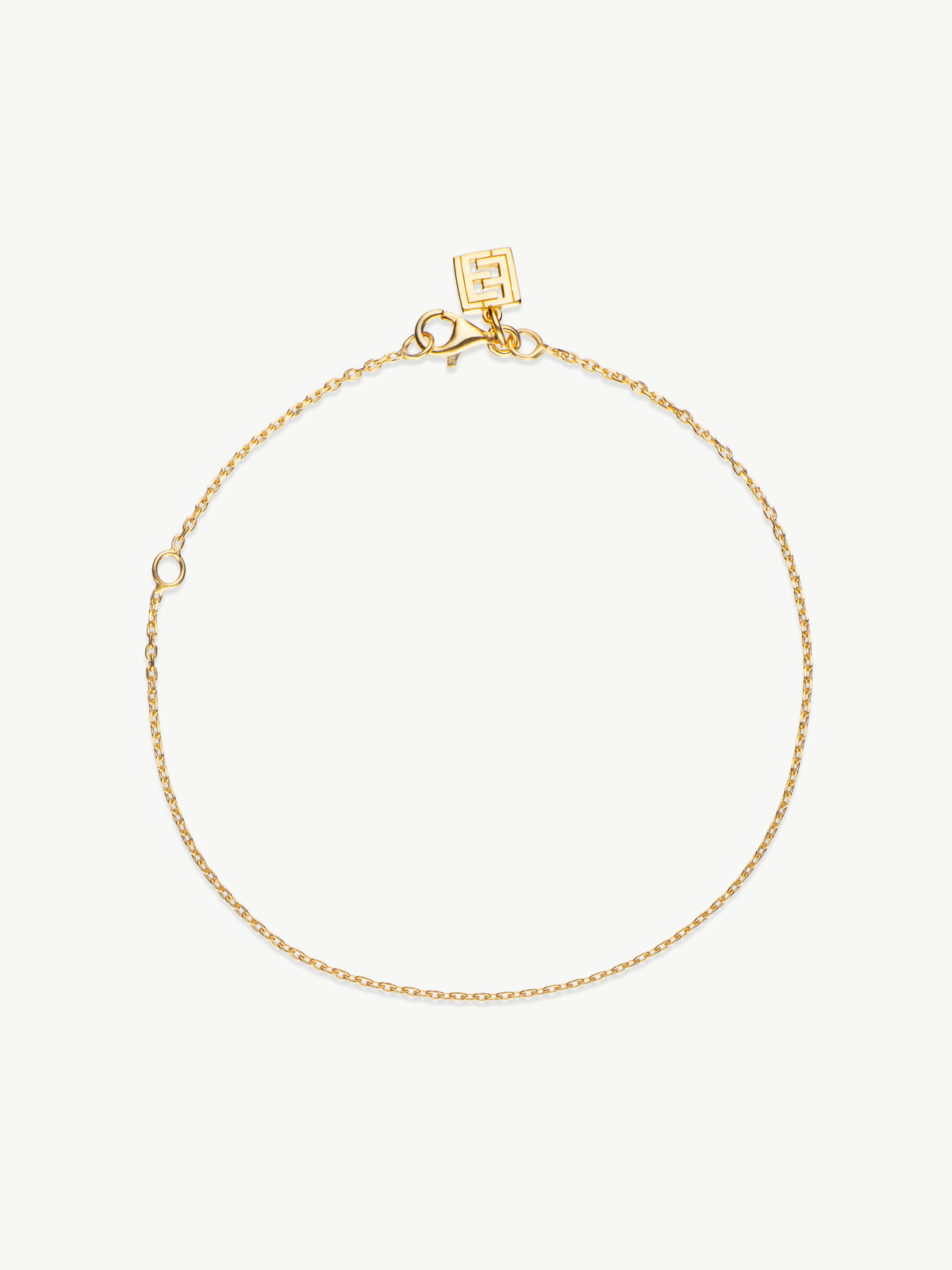 A gold chain bracelet with a lobster clasp and a branded tag, displayed on a white background.