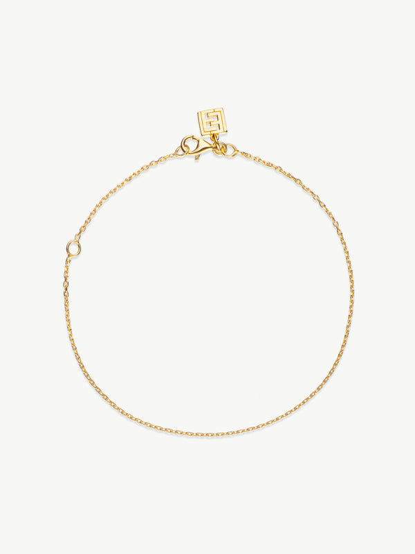 A gold chain bracelet with a lobster clasp and a branded tag, displayed on a white background.