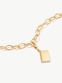 enamel book charm on bracelet in gold