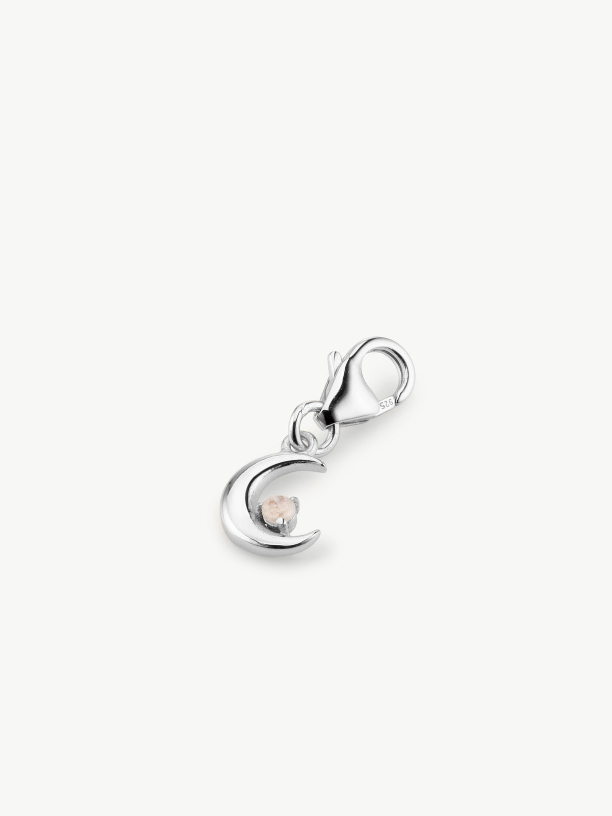 moon charm in silver on surface