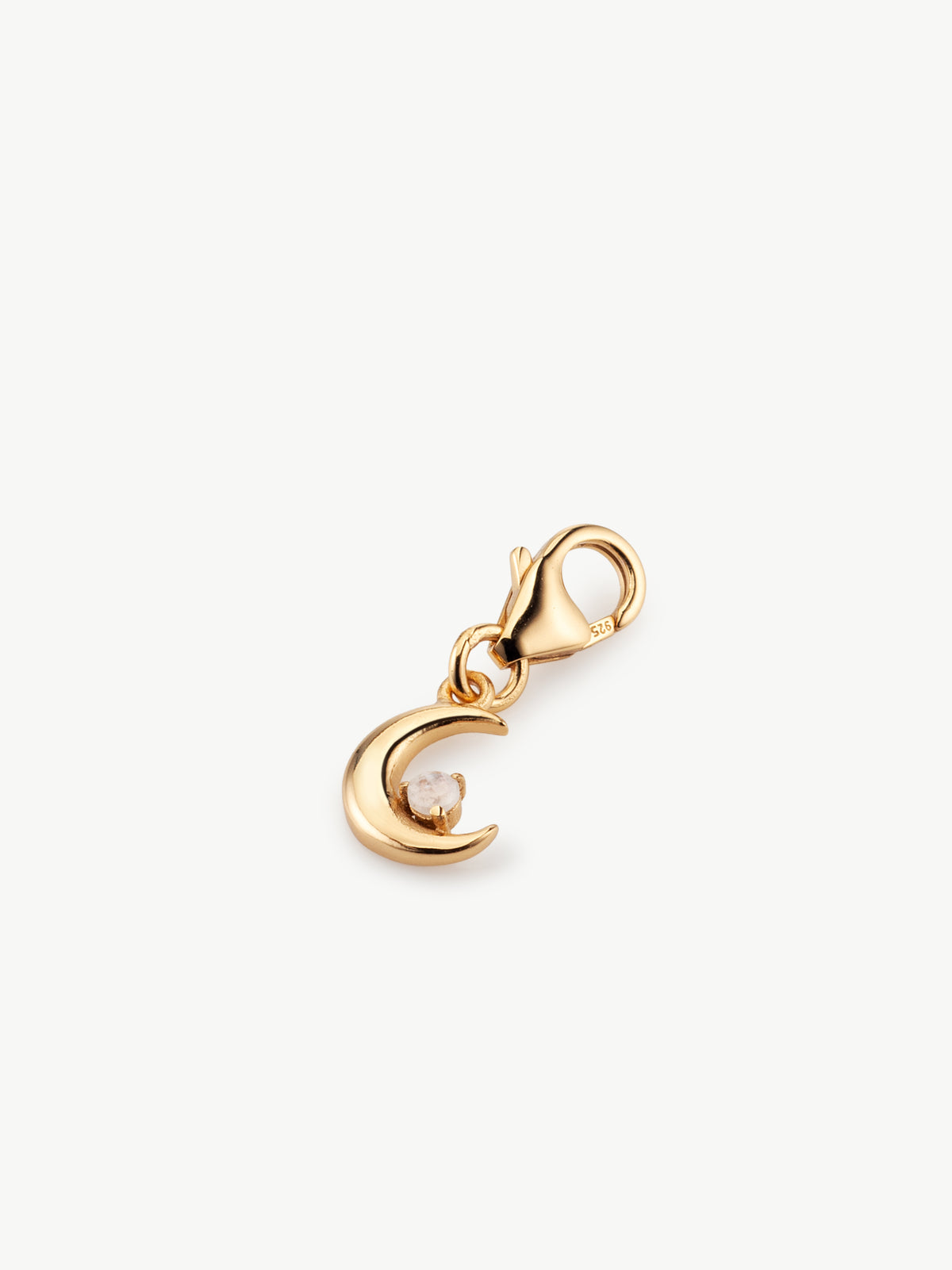 moon charm with moonstone in gold laying flat