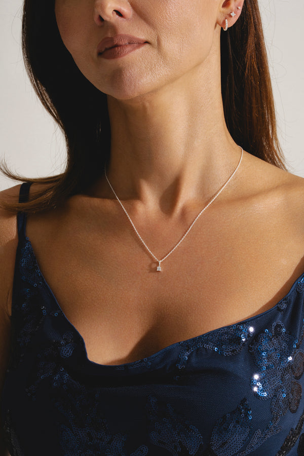 single diamond pendant in sterling silver on model